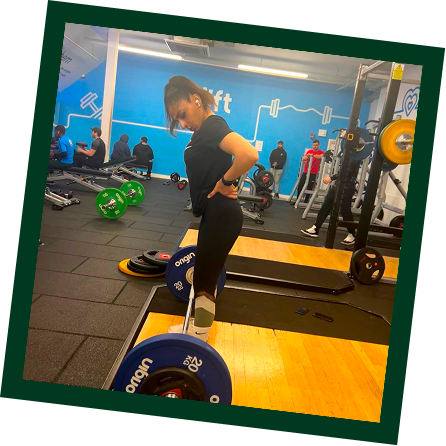 Personal trainer coaching strength training
